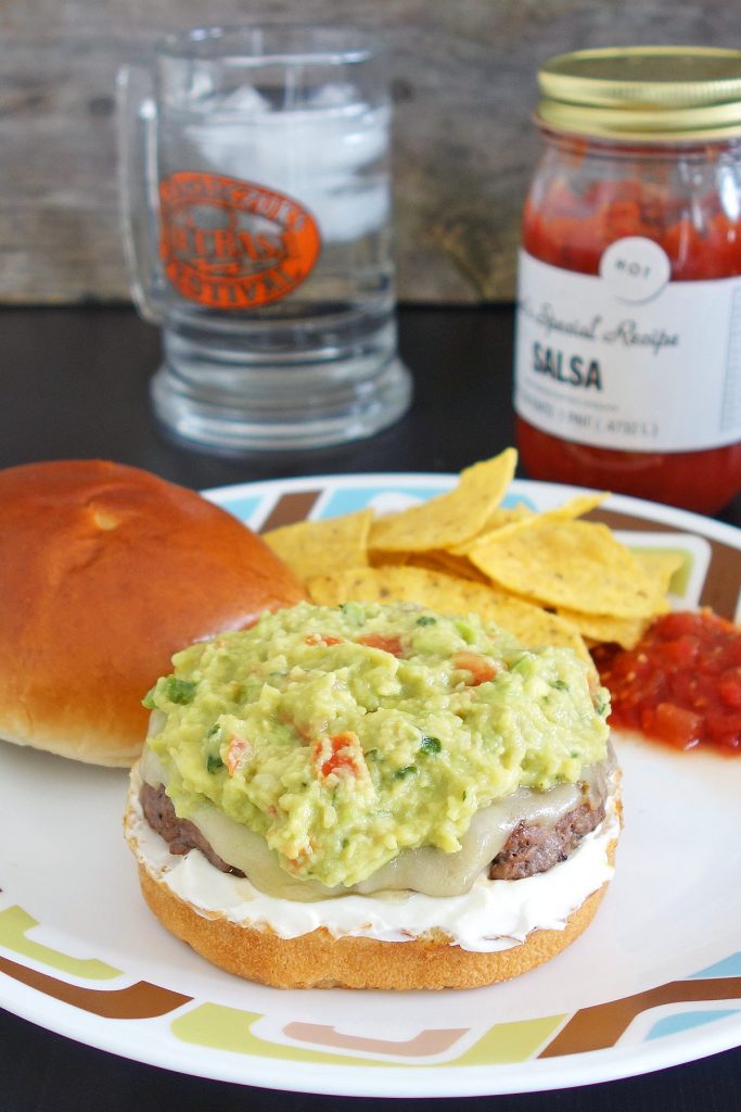 Guacamole burger topped with fresh quac, sour cream, and pepper jack cheese