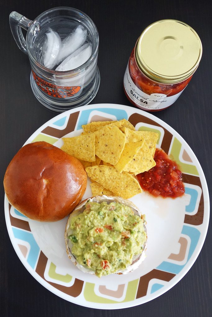 Guacamole burger topped with fresh quac, sour cream, and pepper jack cheese