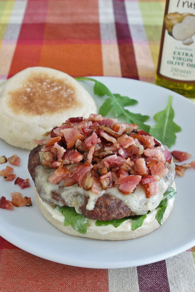 The truffle burger features the delicious flavor of truffle aioli and then is topped off with some diced bacon and onion.