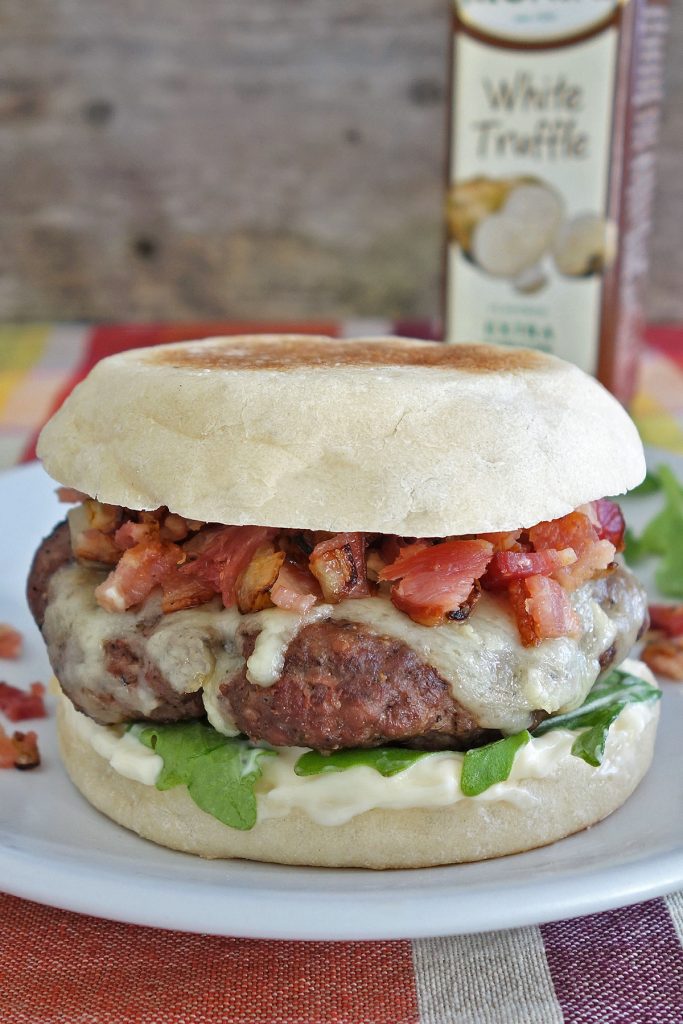 The truffle burger features the delicious flavor of truffle aioli and then is topped off with some diced bacon and onion.