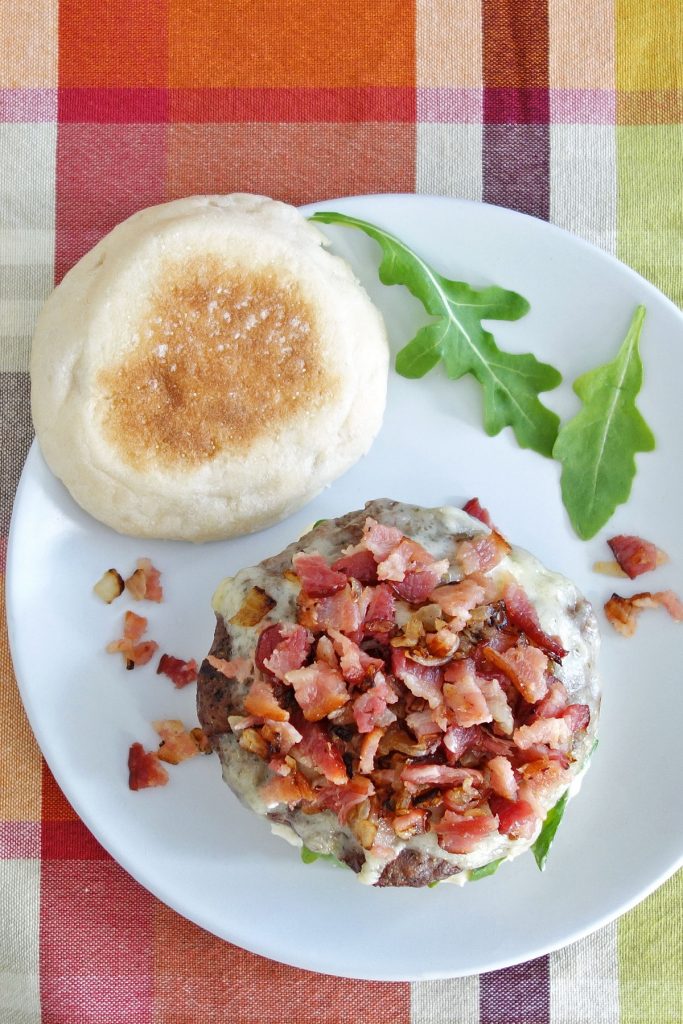 The truffle burger features the delicious flavor of truffle aioli and then is topped off with some diced bacon and onion.